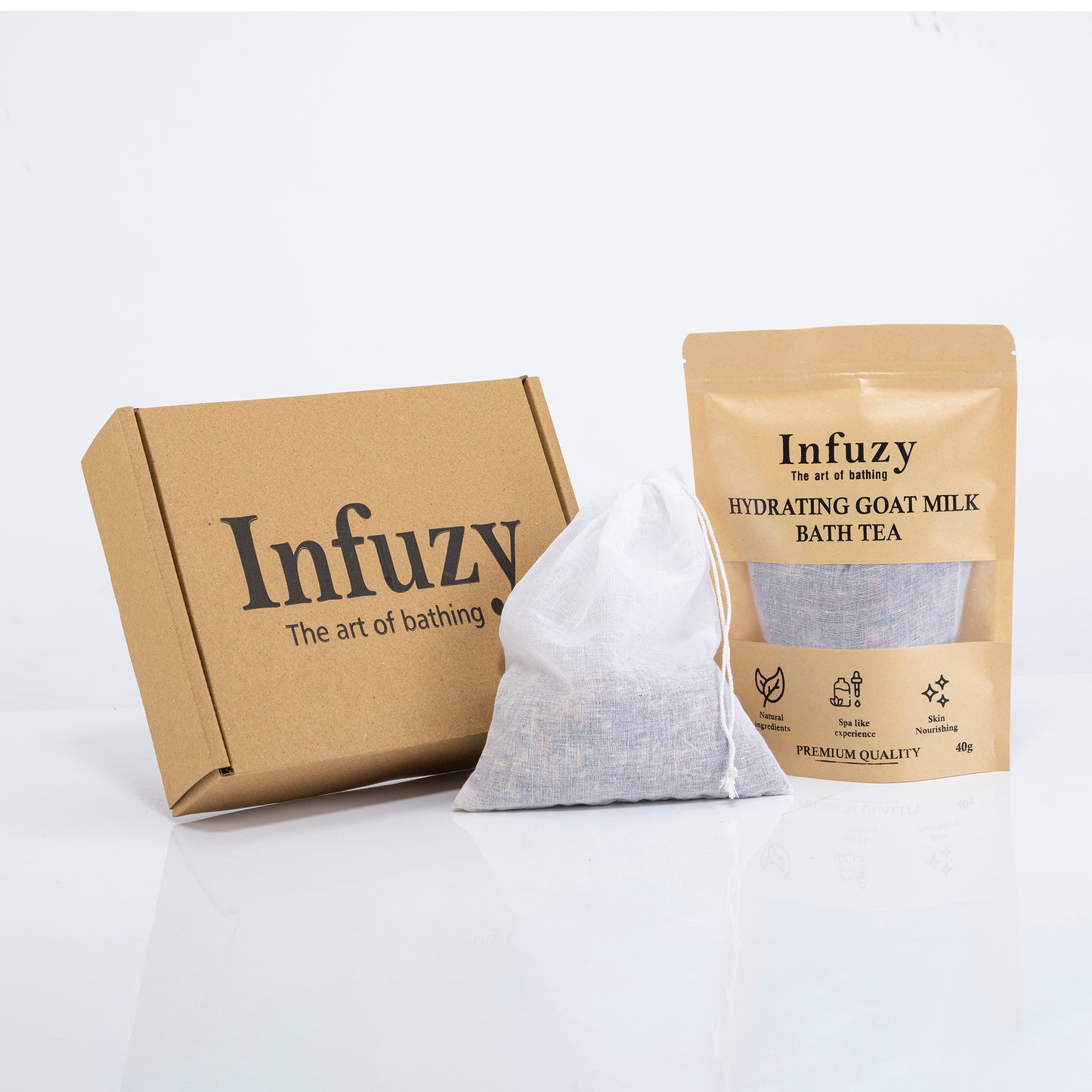 Infuzy packaging including a box, a white bag, and a package of goat milk bath tea on a white background.