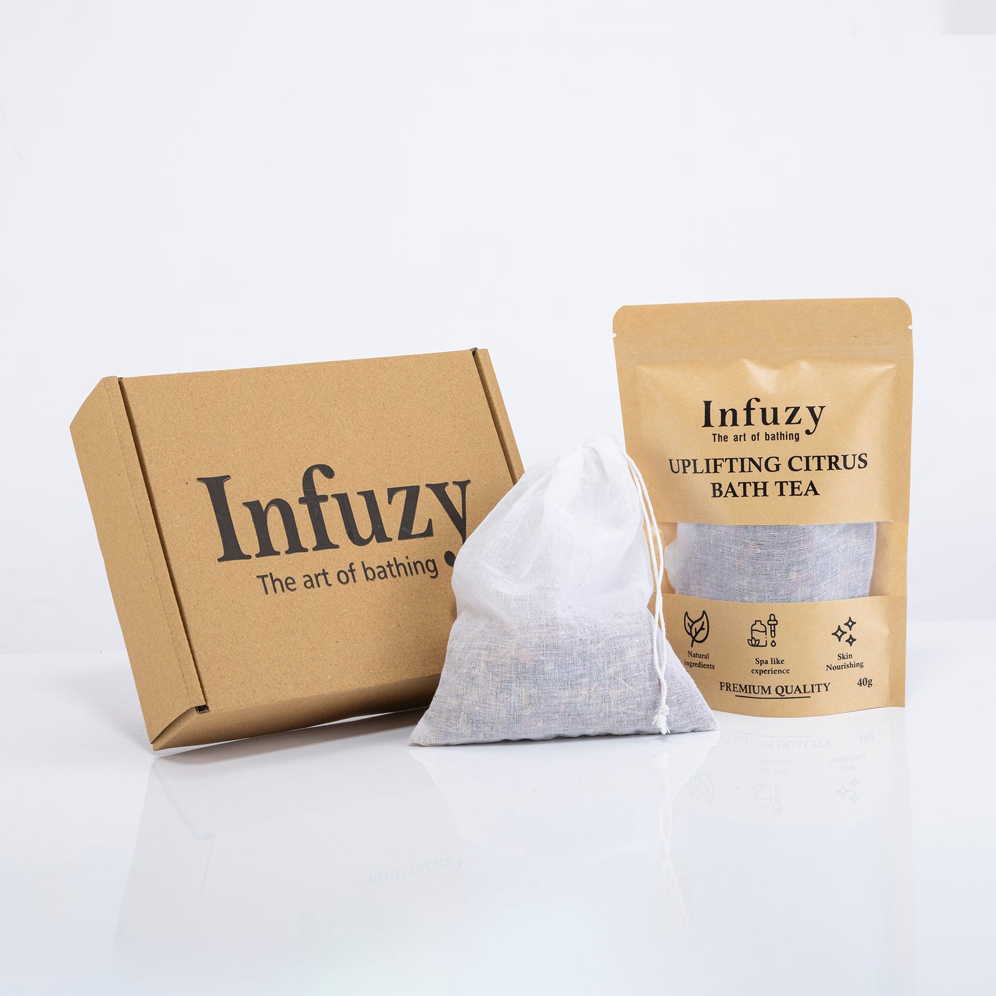 Infuzy bath tea packaging including a cardboard box and a bag with a tea bag inside on a white background.