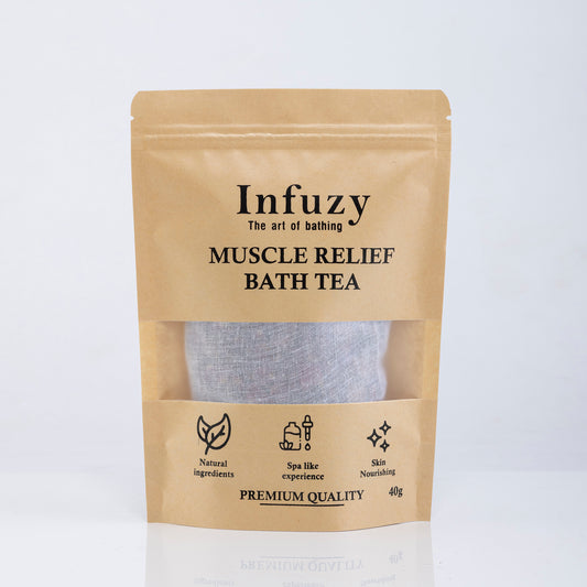 A package of Infuzy Muscle Relief Bath Tea with a visible tea bag through a clear window, labeled as premium quality with various benefits listed, such as all-natural ingredients and 45g weight.
