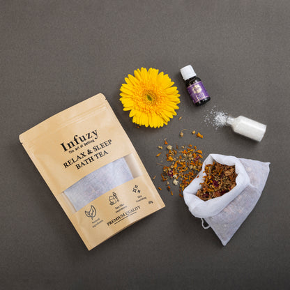 Infuzy relax and sleep bath tea packaging with a yellow flower and essential oil bottle on a gray background
