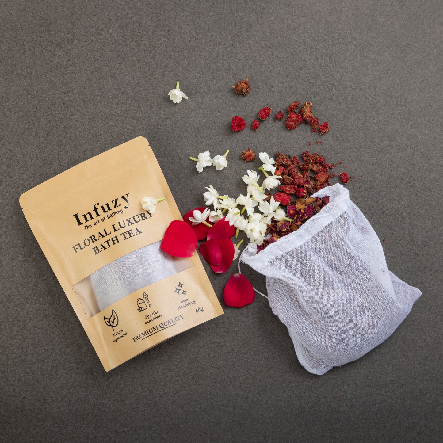 Infuzy floral luxury bath tea package with a mesh bag and dried flowers on a gray background