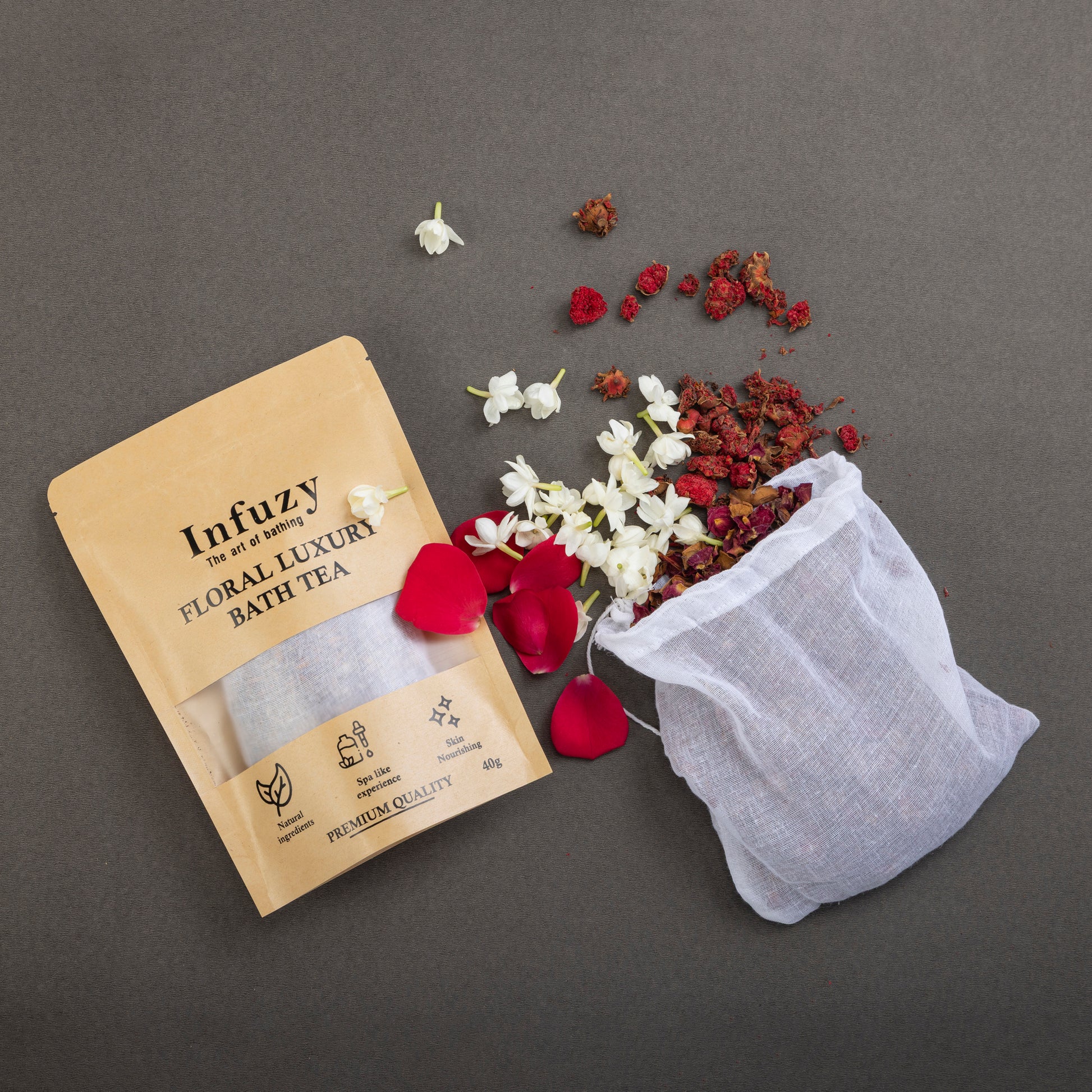 Infuzy floral luxury bath tea package with a mesh bag and dried flowers on a gray background